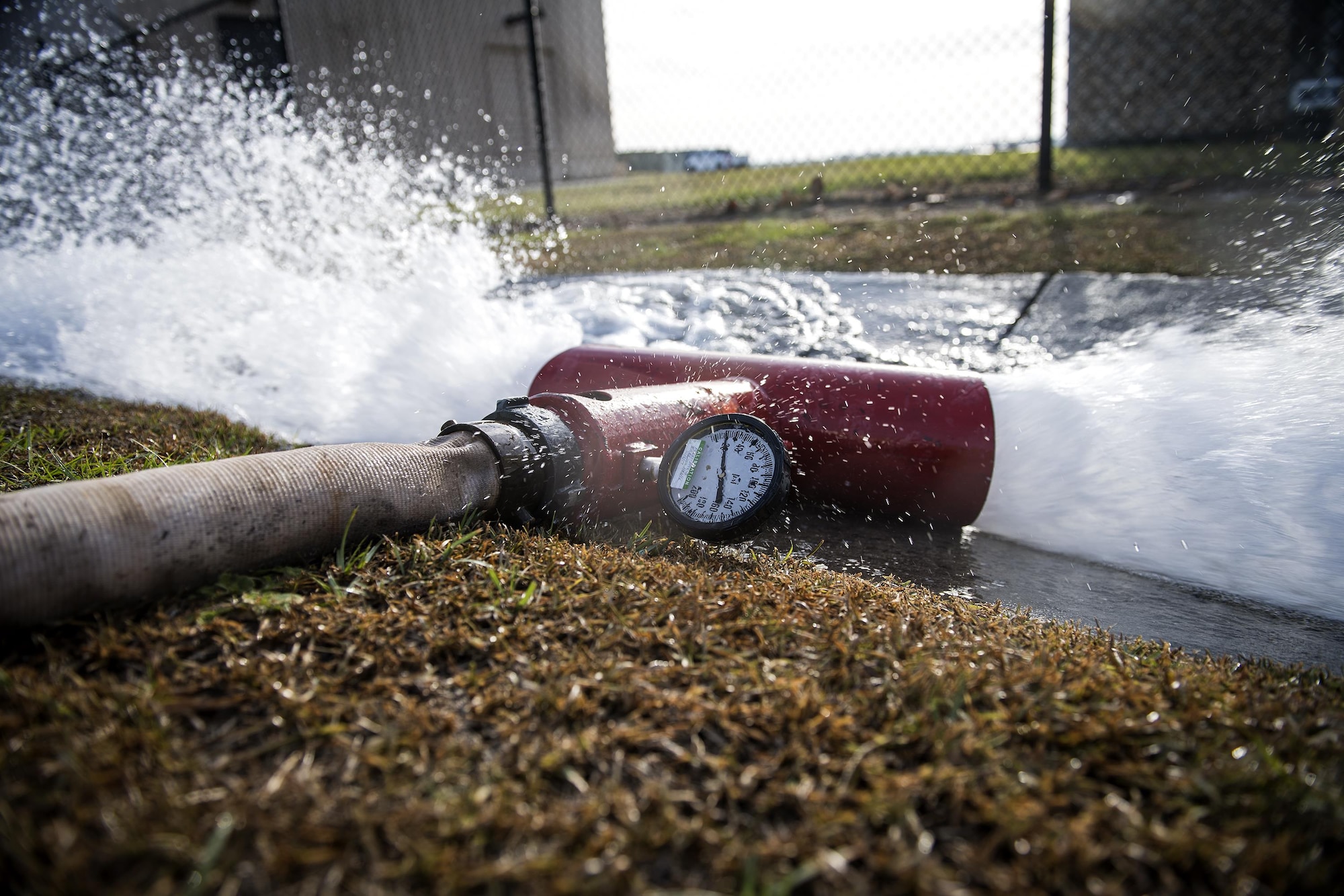 A fire hose connected to a flow device spews water, Oct. 25, 2016, at Moody Air Force Base, Ga. The flow device weighs down the hose and controls the spray, preventing the hose from going wild. It also houses the pitot device which measures the velocity of the water and is used to calculate the amount of gallons flowing per minute. (U.S. Air Force photo by Airman 1st Class Janiqua P. Robinson)