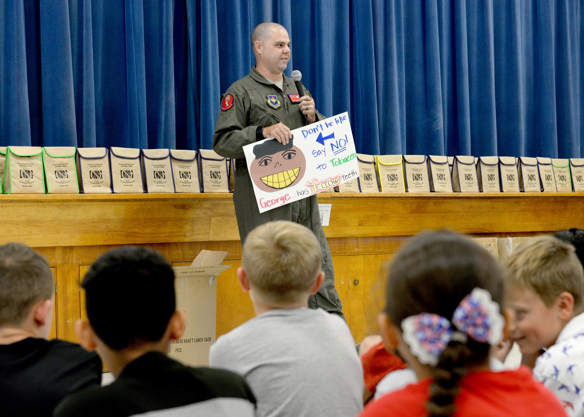 U.S. Air Force Tech Sgt. Michael Barker, 58th Airlift Squadron NCO in charge of tactics flight, educates children at L. Mendel Rivers Elementary School on the dangers of smoking, Oct. 24, 2016, Altus Air Force Base, Okla. DDR is working with the local community to help raise awareness of drug, alcohol and tobacco abuse. (U.S. Air Force Photo by Airman Jackson N. Haddon/Released).