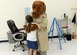 Scruff McGruff, the crime dog, gives hugs and high fives to children at L. Mendel Rivers Elementary School as they leave the Drug Demand Reduction assembly, Oct. 24, 2016, Altus Air Force Base, Okla. DDR is working with the local community to help raise awareness of drug and alcohol abuse. (U.S. Air Force Photo by Airman Jackson N. Haddon/Released).