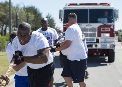 Members of Joint Base San Antonio-Randolph 902nd Security Forces Squadron perform a fire truck pull during the Battle of the Badges competition at Eberle Park on JBSA-Randolph Oct. 22, 2016. The Battle of the Badges is an annual competition between the 902nd Security Forces Squadron “Defenders” and the JBSA-Randolph FES “Fire Dawgs.” 