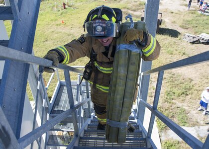 Airman 1st Class Gavin Maltais, Joint Base San Antonio-Randolph Fire Emergency Services firefighter, competes in the firefighter combat challenge during the Battle of the Badges competition at Eberle Park on JBSA-Randolph Oct. 22, 2016. In Battle of the Badges, members of the 902nd Security Forces Squadron and the JBSA-Randolph FES face off in various events, including a tactical shooting challenge, firefighter combat challenge and a fire truck pull. 