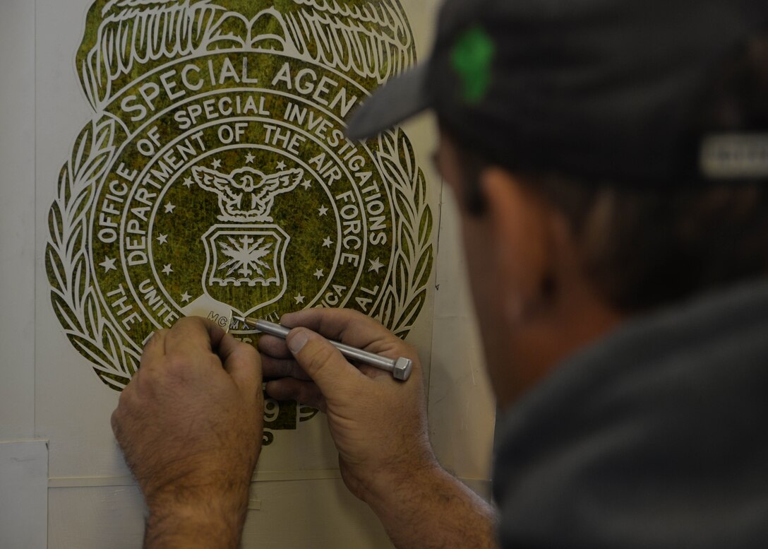 Mark Luken, engraver at West River Monument Company, places a stencil on a memorial monument in Rapid City, S.D., Oct. 18, 2016. This monument memorializes Special Agent Peter Taub, an OSI agent who was killed in action near Bagram Airfield, Afghanistan Dec. 21, 2015. (U.S. Air Force photo by Senior Airman Rebecca Imwalle)