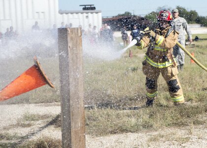 Staff Sgt. Garcia Tarver, Joint Base San Antonio-Randolph Fire Emergency Services firefighter, competes in the firefighter combat challenge during the Battle of the Badges competition at Eberle Park on JBSA-Randolph Oct. 22, 2016. In Battle of the Badges, members of the 902nd Security Forces Squadron and the JBSA-Randolph FES face off in various events, including a tactical shooting challenge, firefighter combat challenge and a fire truck pull. 