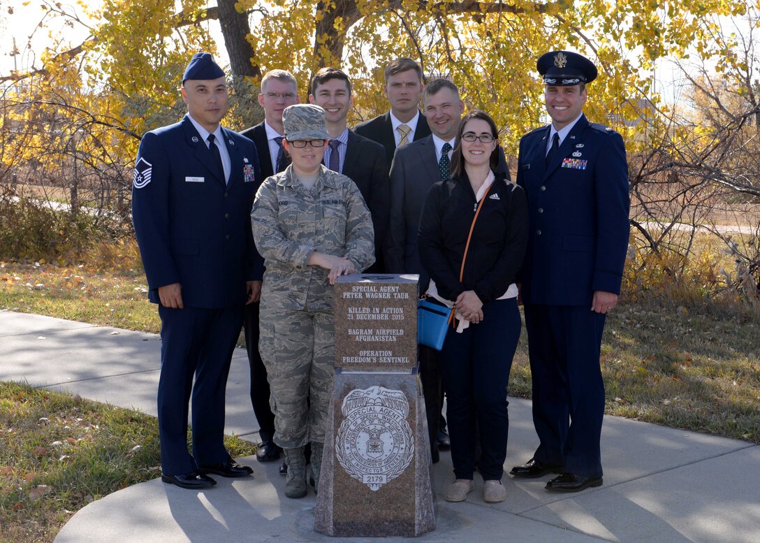 Air Force Office of Special Investigations agents paid tribute to a fallen agent by conducting a memorial unveiling ceremony at Ellsworth Air Force Base, S.D., Oct. 21, 2016. This monument memorializes Special Agent Peter Taub, an OSI agent who was killed in action near Bagram Airfield, Afghanistan in Dec. 21, 2015. (U.S. Air Force photo by Senior Airman Rebecca Imwalle)