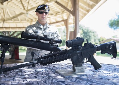 Tech. Sgt. Johnathan Kuenzli, 902nd Security Forces Squadron NCO in charge, combat arms, mans a weapons display during the Battle of the Badges at Eberle Park on Joint Base San Antonio-Randolph Oct. 22, 2016. The Battle of the Badges is an annual competition between the 902nd Security Forces Squadron “Defenders” and the JBSA-Randolph FES “Fire Dawgs.” 