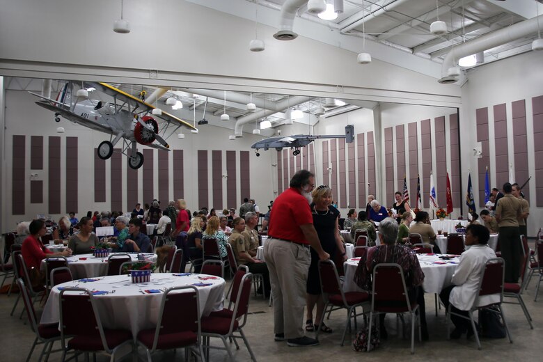 Attendees of the 2016 Salute to Women of the Military event mingle at the Tourist and Event Center in Havelock, N.C., Oct. 20, 2016. In 1987, Bee Mayo and Jean Nelson first discussed the idea of recognizing contributions made by women in the military. Today, that legacy lives on in the Eastern North Carolina area through the Salute to Women of the Military. The event continues to identify women as a vital part of the U.S. Armed Forces. Women from all branches of the military who served in the past or are currently serving came to support the occasion. Mayo is a board member of the Craven County Council on Women, and Nelson is the regional director for the NC Council for Women. (U.S. Marine Corps photo by Lance Cpl. Mackenzie Gibson/Released)