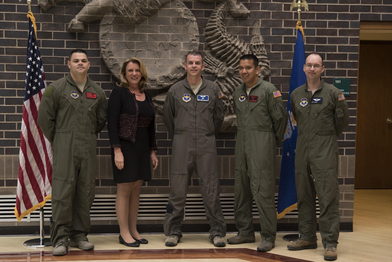 Secretary of the Air Force Deborah Lee James poses with the first four Enlisted Pilot Initial Class students in the U.S. Air Force Initial Flight Training School at Pueblo Memorial Airport in Pueblo, Colorado Oct. 17. The Air Force announced the initiative to integrate the enlisted force into Remotely Piloted Aircraft flying operations as pilots Dec. 17, 2015 starting with the RQ-4 Global Hawk. Name badges were blurred due to Air Force limits on disclosure of identifying information for RPA operators.