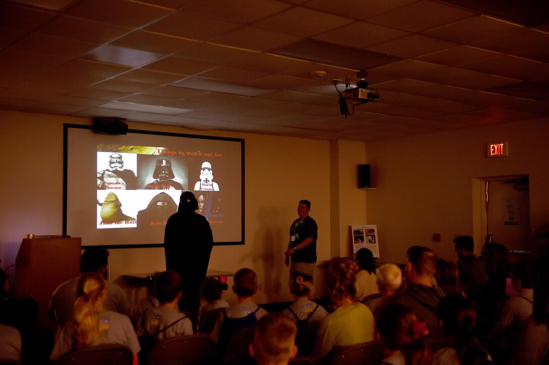 An Operation Dyess Kids volunteer dressed as Darth Vader speaks to children during the event at Dyess Air Force Base, Texas, Oct. 22, 2016. This Star Wars themed mock deployment sent children to the planet of Naboo to fight off imperial forces. (U.S. Air Force photo by Staff Sgt. Kia Atkins)