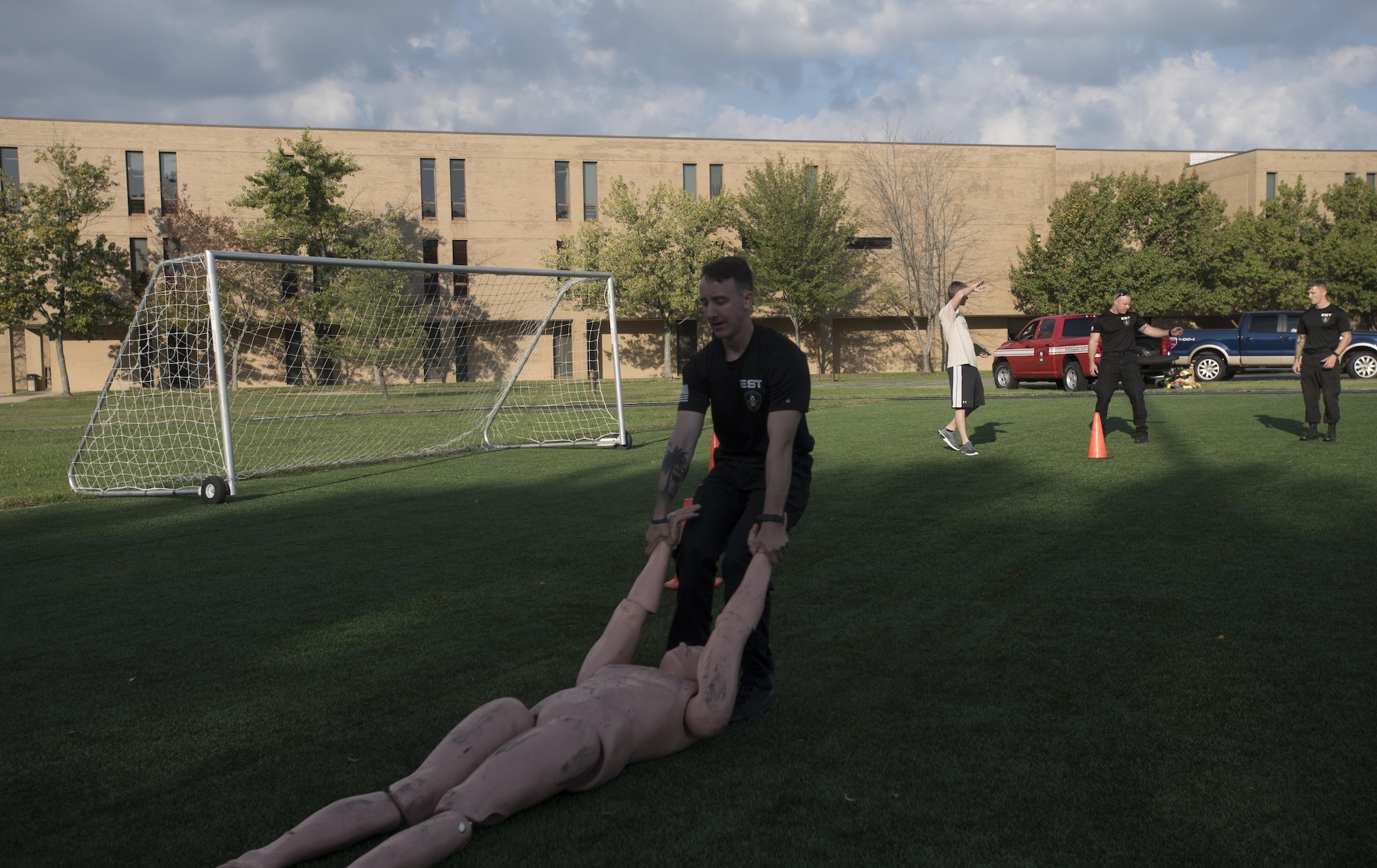Senior Airman Brian Jurek, 11th Security Force Squadron emergency service team member, drags a dummy during the inaugural Battle of the Badges at Joint Base Andrews, Md., Oct. 21, 2016. Nine teams competed in timed events including a litter carry, dummy drag, weapons assembly and half-mile run while holding an explosive ordinance disposal training device. (U.S. Air Force photo by Airman 1st Class Rustie Kramer) 
