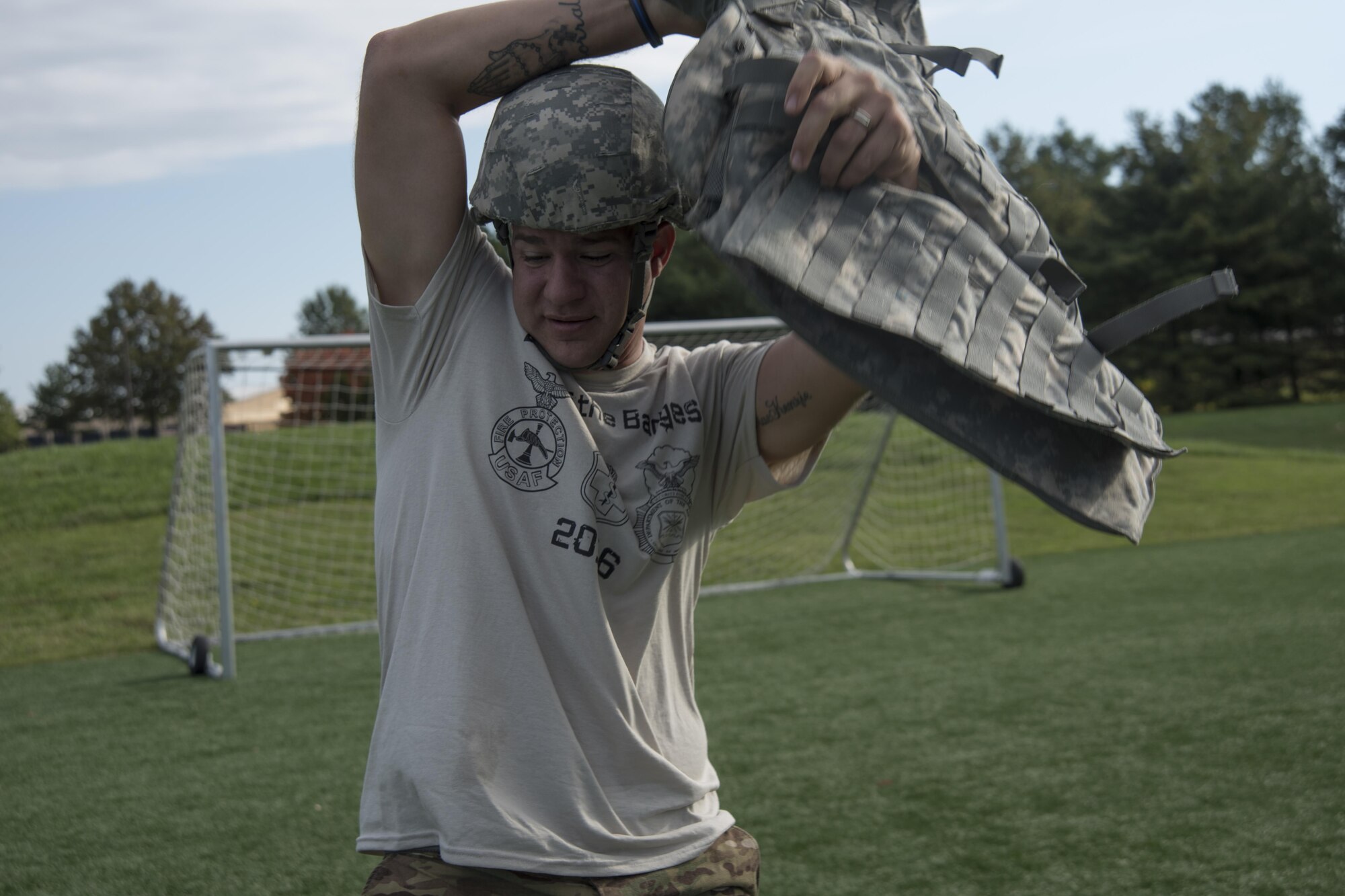 Staff Sgt. Courtney Corral, 11th Security Support Squadron security forces trainer, puts on a flak vest before an event during the Battle of the Badges at Joint Base Andrews, Md., Oct. 21, 2016. Nine teams competed in timed events including a litter carry, dummy drag, weapons assembly and half-mile run while holding an explosive ordinance disposal training device.  This was the first year the event was held at JBA. (U.S. Air Force Photo by Airman 1st Class Rustie Kramer)  