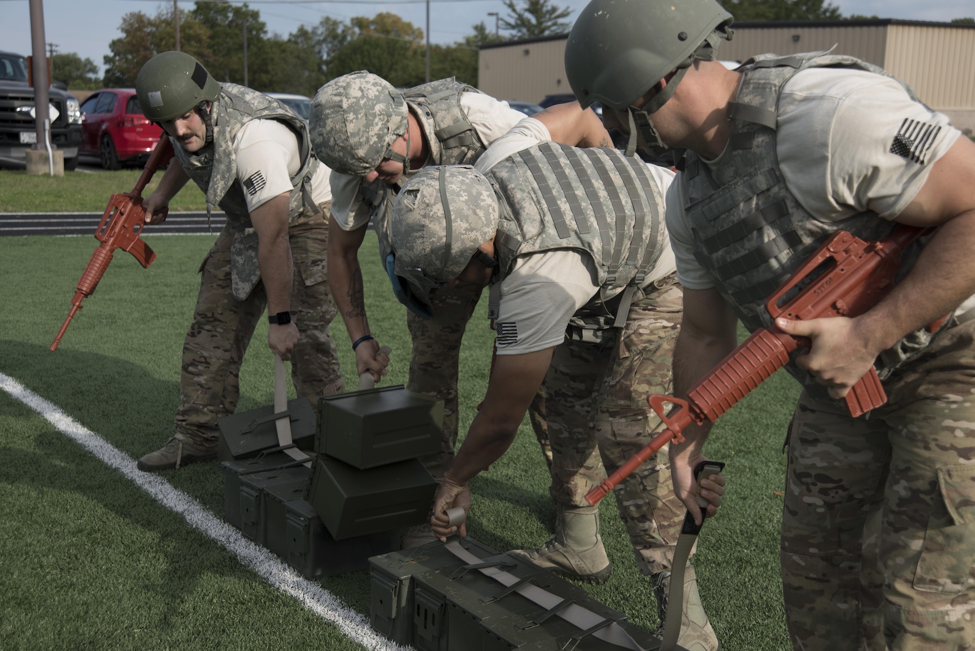 Members of the 11th Security Support Squadron compete in a timed event during the inaugural Battle of the Badges at Joint Base Andrews, Md., Oct. 21, 2016.  Teams were challenged with carrying 13 ammunition cans and weapons 40 yards without allowing them to touch the ground. (U.S. Air Force Photo by Airman 1st Class Rustie Kramer) 
