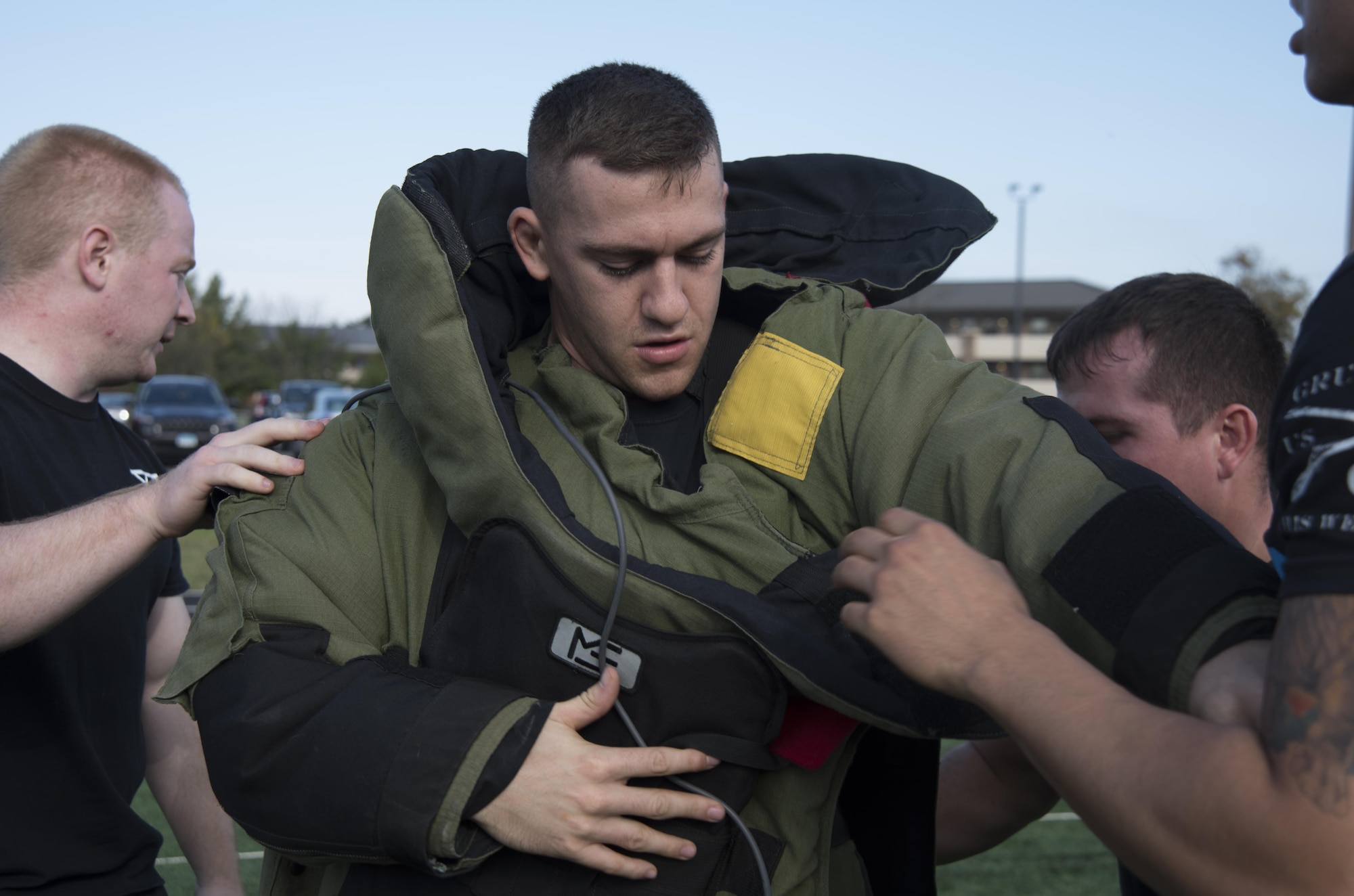 Senior Airman Brandon Thompson, 11th Security Forces Squadron security forces member, receives help from teammates while putting on an explosive ordinance disposal suit during the Battle of the Badges at Joint Base Andrews, Md., Oct. 21, 2016. Battle of the Badges is a competition between JBA’s emergency response teams held to bring the emergency units together and build camaraderie through friendly competition. (U.S. Air Force photo by Airman 1st Class Rustie Kramer) 
