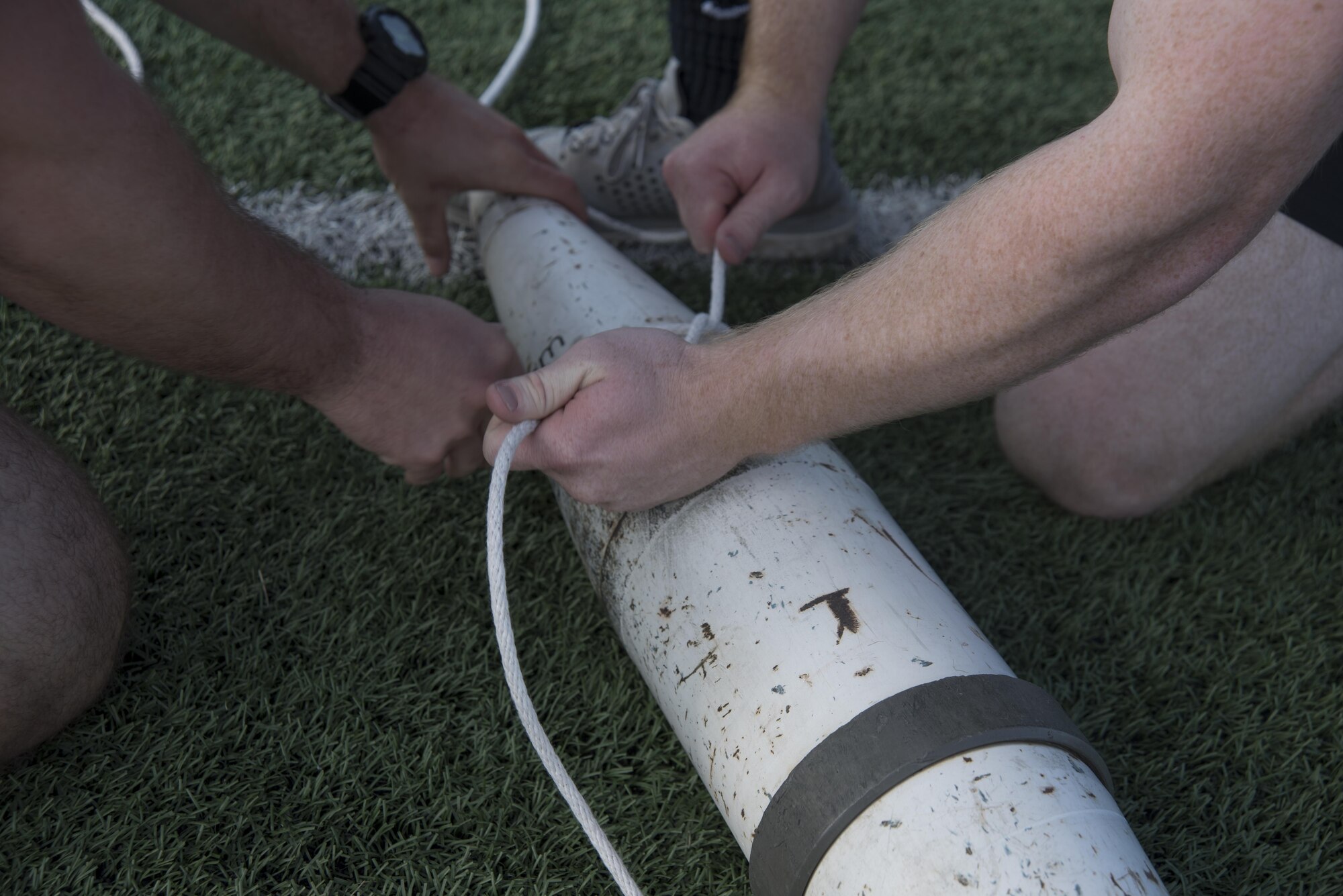 Staff Sgt. Jeffrey Reinke and Senior Airman Michael Norris, 11th Security Forces Squadron security forces members, tie a rope to an explosive ordinance disposal training device during the Battle of the Badges at Joint Base Andrews, Md., Oct. 21, 2016. Battle of the Badges was a competition between JBA’s emergency response units held, to bring the emergency units together to build camaraderie through friendly competition. (U.S. Air Force photo by Airman 1st Class Rustie Kramer)  
