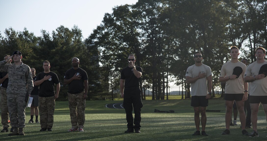 Staff Sgt. Joshua Gilbertson, 11th Security Forces Squadron emergency services team NCO in charge, sings the “Star Spangled Banner” at the opening of the inaugural Battle of the Badges at Joint Base Andrews, Md., Oct. 21, 2016. Battle of the Badges was a competition between JBA’s emergency response units, held to bring the groups together to build camaraderie through friendly competition. (U.S. Air Force photo by Airman 1st Class Rustie Kramer) 