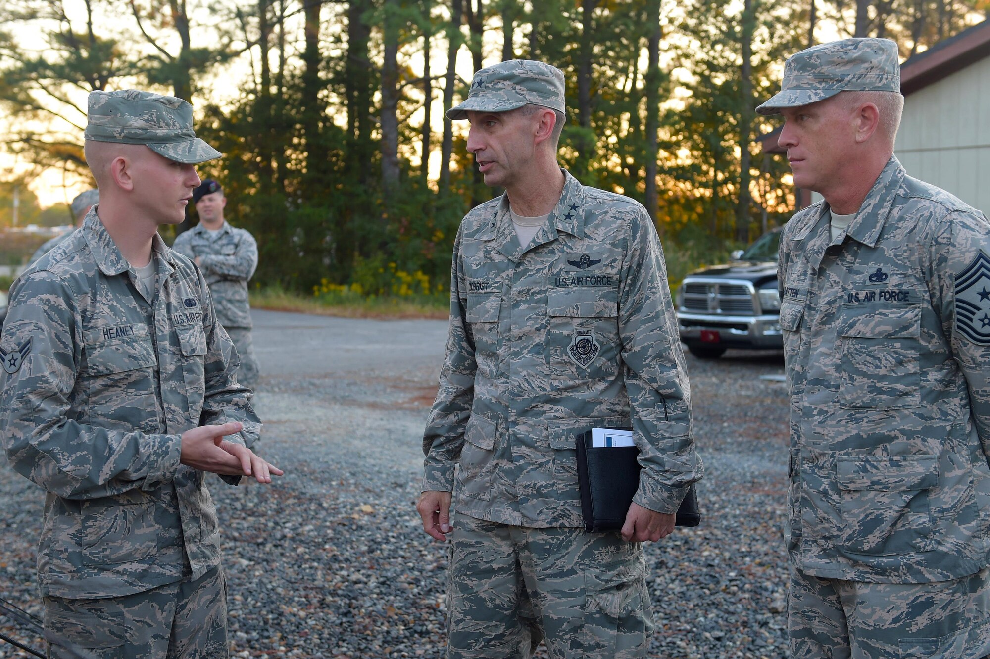 U.S. Air Force Airman 1st Class Alousha Heaney, 633rd Force Support Squadron services journeyman, briefs Maj. Gen. Scott Zobrist, 9th Air Force commander, and Chief Master Sgt. Frank Batten, 9th AF command chief, during a visit at Joint Base Langley-Eusits, Va., Oct. 18, 2016. Heaney showed them a full service single pallet expeditionary kitchen set up for a 633rd Medical Group exercise. (U.S. Air Force photo by Senior Airman Kimberly Nagle)  
