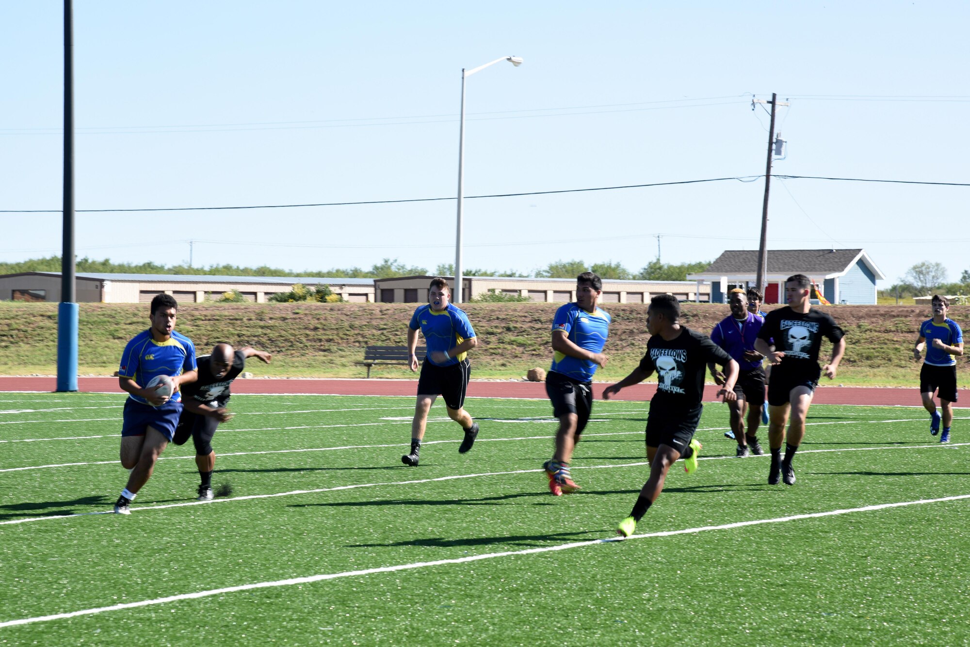 The Badfellows, Goodfellow’s rugby team, and  Angelo State University Flying Rams’ freshman rugby team play a match during the Make Goodfellow Great Trucktoberfest event at the football field on Goodfellow Air Force Base, Texas, Oct. 21, 2016. The Goodfellow Airman who formed the Badfellows is currently a rugby player for the Flying Rams. (U.S. Air Force photo by Senior Airman Joshua Edwards/Released)