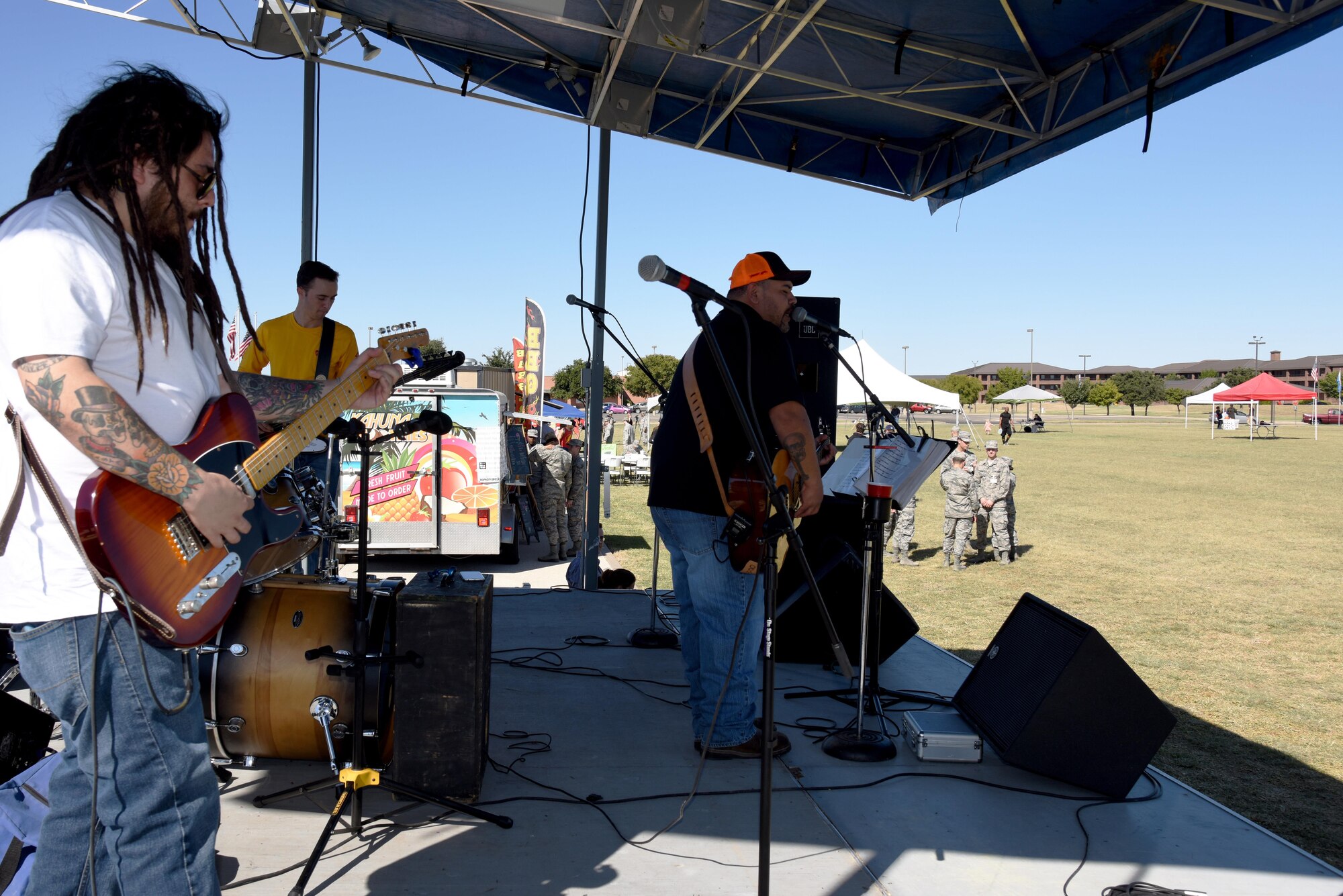 The Back Road Trubadors play for the Make Goodfellow Great Trucktoberfest event at the parade grounds on Goodfellow Air Force Base, Texas, Oct. 21, 2016. During Trucktoberfest, individuals could sign up for a Goodfellow club or get food from various local food truck vendors. (U.S. Air Force photo by Senior Airman Joshua Edwards/Released)