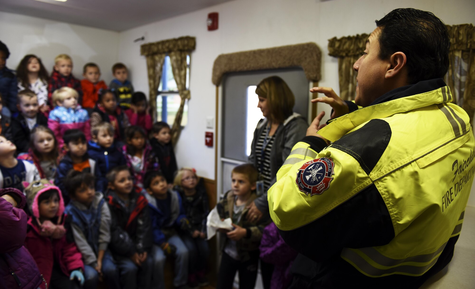 Bryant Benitez, 92nd Civil Engineer Squadron fire inspector, talks to students form Michael Anderson Elementary School Oct. 11, 2016, at Fairchild Air Force Base. Fire Prevention Week is a nationally recognized event the second week of October. Fairchild fire fighters hosted several events for the base including talks with students at Michael Anderson and a fire prevention carnival. (U.S. Air Force photo/ Airman 1st Class Sean Campbell) 