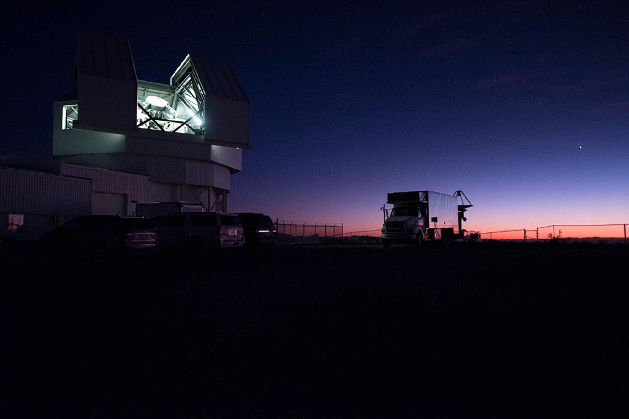 WHITE SANDS MISSILE RANGE, N.M. - Light emits from the dome of the Space Surveillance Telescope near White Sands Missile Range, New Mexico, Oct. 18, 2016. The telescope was designed for space situational awareness and will be moved to Australia to become part of the 21st Space Wing’s network of ground-based sensors by 2020. (Courtesy photo)
