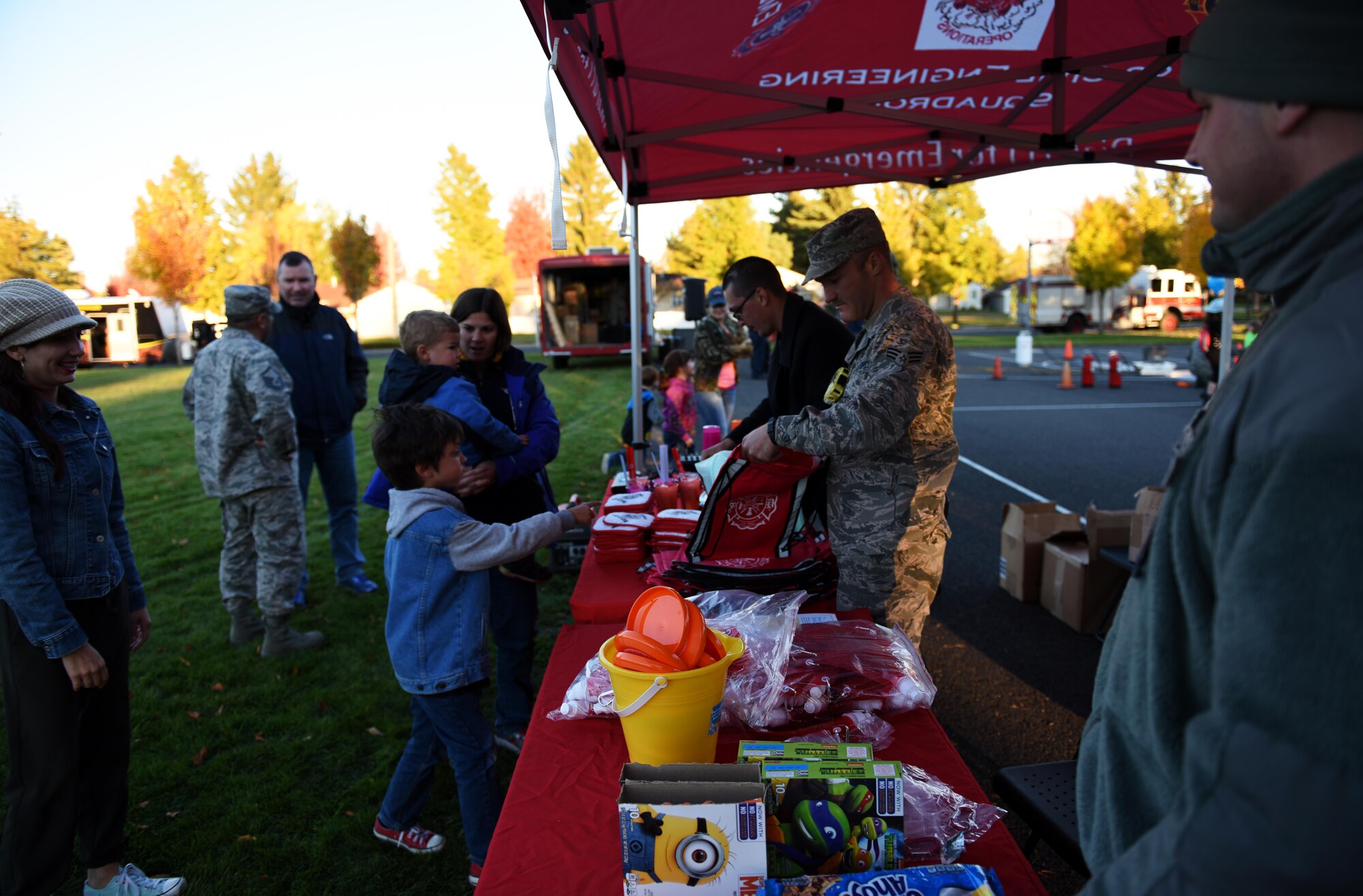 Firefighters from the 92nd Civil Engineer Squadron hand out goodie bags to Team Fairchild families as part of the Fire Prevention Week Carnival Oct. 12, 2016, at Fairchild Air Force Base. Fire Prevention Week was started in 1922 to commemorate the Great Chicago Fire in 1871. The fire killed 250 people, left 100,000 homeless and burned more than 2,000 acres. According to the National Fire Protection Association, the Great Chicago fire drastically changed the way the public and firefighters think about fire prevention. The International Fire Marshals Association decided the anniversary of the Great Chicago Fire should be used to spread fire safety awareness. (U.S. Air Force photo/Airman 1st Class Sean Campbell)
