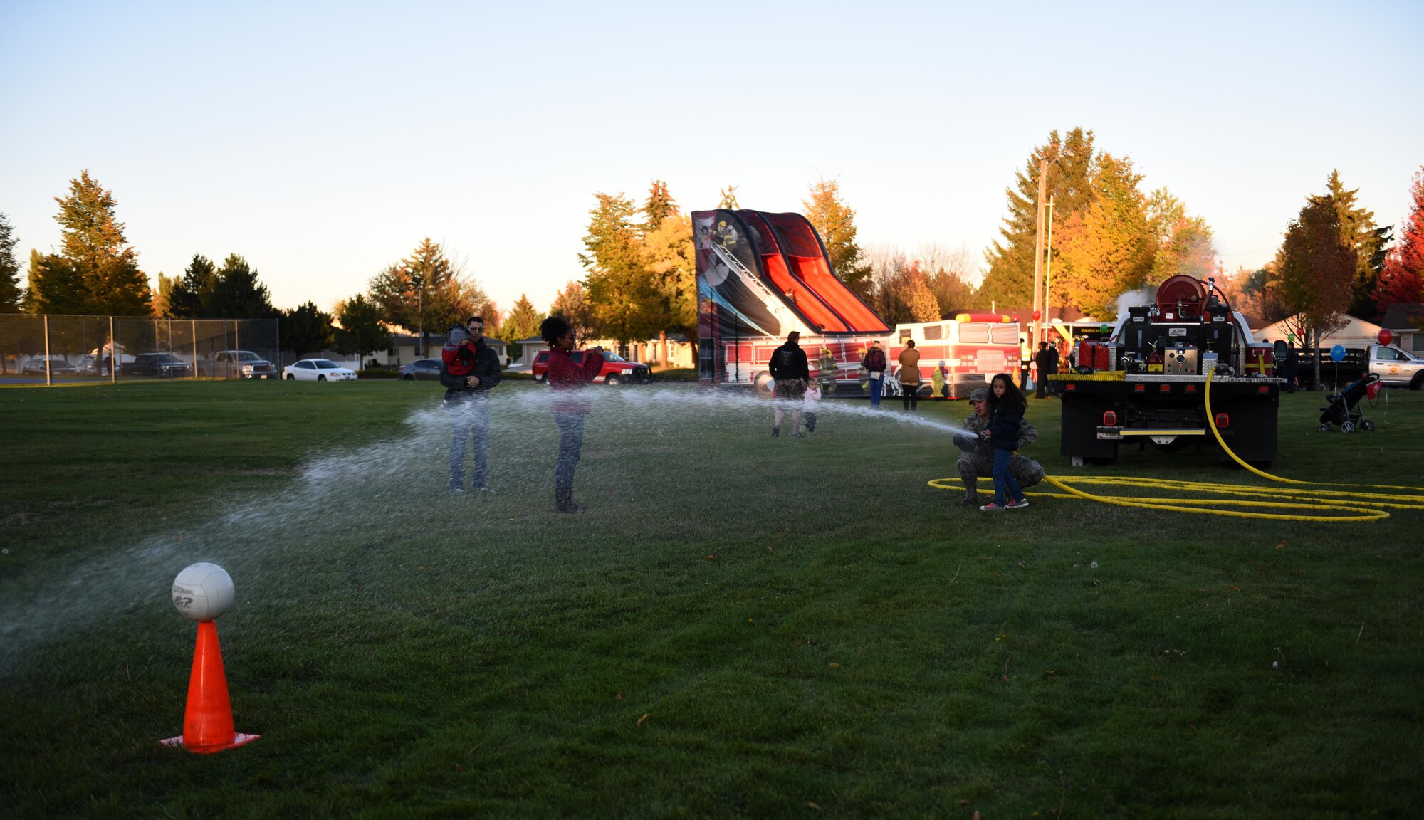 Members of Team Fairchild practice aiming a fire hose during the Fire Prevention Week Carnival Oct. 12, 2016, at Fairchild Air Force Base. This year’s slogan was “Don’t wait, check the date,” reminding people that smoke detectors need to be changed every 10 years. The goal of Fire Prevention Week is to spread fire prevention awareness. (U.S. Air Force photo/Airman 1st Class Sean Campbell)