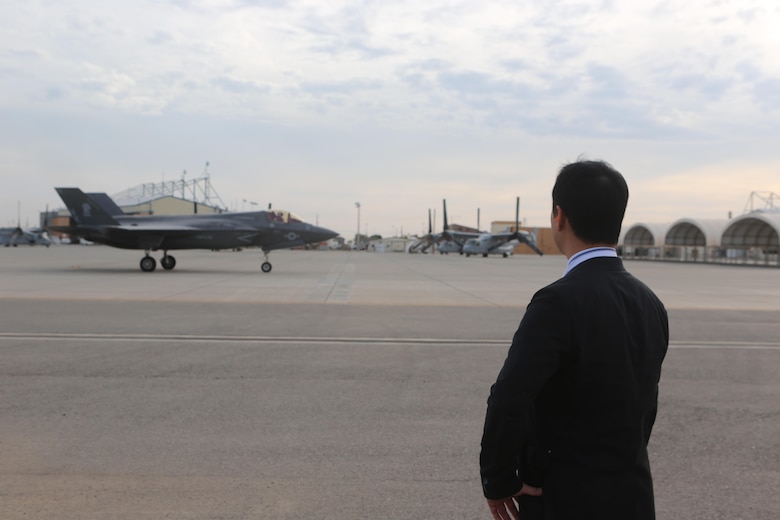 Yoshihiko Fukuda, mayor of Iwakuni, Japan, watches an F-35B Lightning II taxi down the flight line aboard Marine Corps Air Station Yuma, Ariz., Oct. 24. Fukuda visited the air station to speak with Marine Corps aviation officials, observe the capabilities of the F-35B Lightning II and expand his knowledge of the aircraft before Marine Fighter Attack Squadron (VMFA) 121 relocates to MCAS Iwakuni next year. (U.S. Marine Corps photo by Lance Cpl. Harley Robinson/Released)