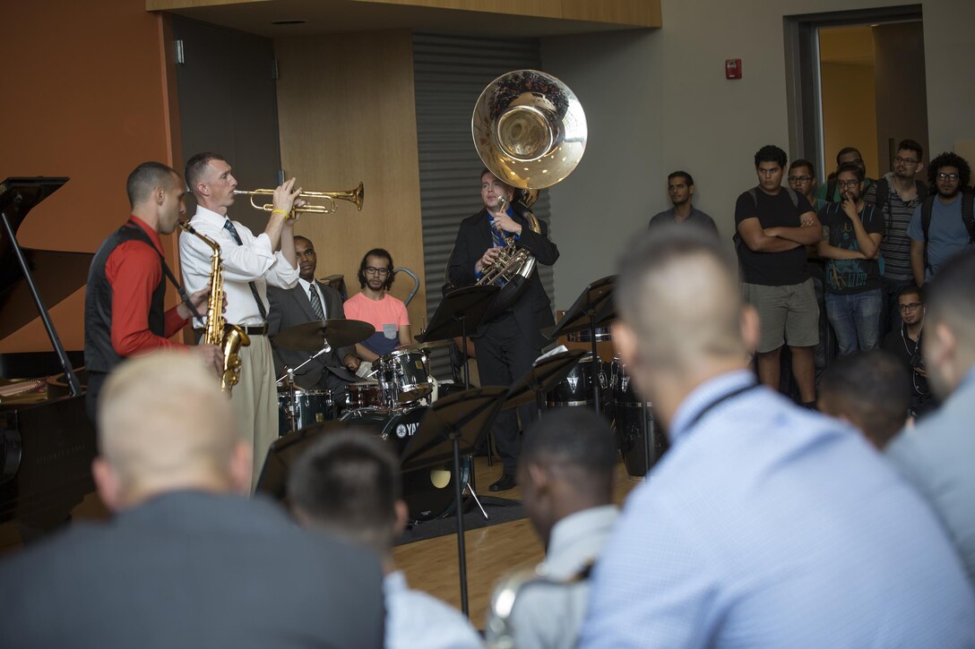 Staff Sgt. Mark A. Pellon (left), 12th Marine Corps district musician placement director, and a guest saxophone player with Marine Corps Band New Orleans, and Master Sgt. Timothy Otis (right), Marine Corps recruiting command head musician procurement, and trumpet player, demonstrate a song while teaching a Master class on music to students attending the Conservatorio de Musica de Puerto Rico in San Juan, before kicking off the Marine Corps Reserve Centennial celebration concert on Oct. 18, 2016. The Marine Corps Reserve is commemorating 100 years of rich history, heritage, espirit-de-corps, and a bond with Puerto Rico and communities across the U.S. The celebration recognizes the Reserve's essential role as a crisis response force and expeditionary force in readiness, constantly preparing to augment the active component. (U.S. Marine photo by Sgt. Sara Graham/Released)