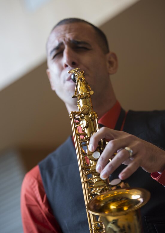 Staff Sgt. Mark A. Pellon, 12th Marine Corps district musician placement director, and a guest saxophone player with Marine Corps Band New Orleans, gives a demonstration to students attending the Conservatorio de Musica de Puerto Rico in San Juan, before kicking off the Marine Corps Reserve Centennial celebration concert on Oct. 18, 2016. The Marine Corps Reserve is commemorating 100 years of rich history, heritage, espirit-de-corps, and a bond with Puerto Rico and communities across the U.S The celebration recognizes the Reserve's essential role as a crisis response force and expeditionary force in readiness, constantly preparing to augment the active component. (U.S. Marine photo by Sgt. Sara Graham/Released)