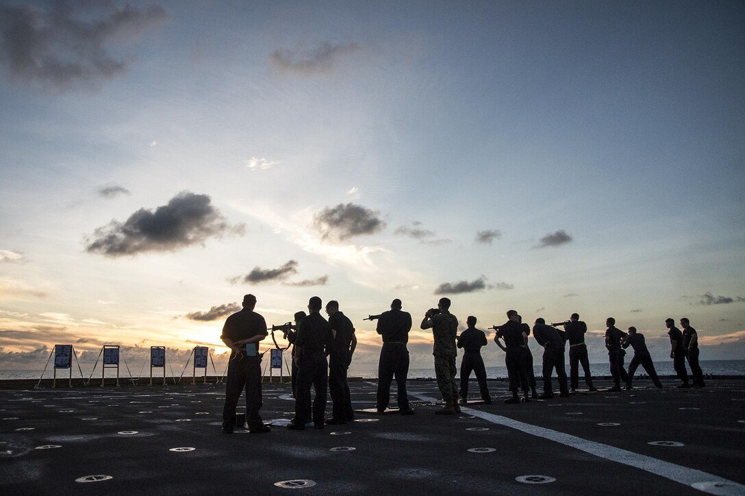 Sailors assigned to the USS Germantown participate in an M16 small-arms weapons qualification on the ship's flight deck in the South China Sea, Oct. 23, 2016. The amphibious dock landing ship is supporting security and stability in the Indo-Asia-Pacific region. Navy photo by Petty Officer 2nd Class Raymond D. Diaz III