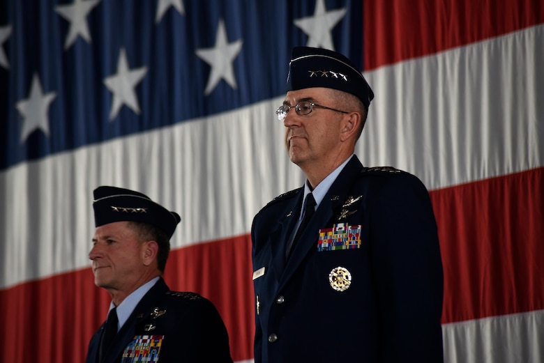 From right, Gen. John Hyten, outgoing commander of Air Force Space Command, takes in the moment as Air Force Chief of Staff Gen. David L. Goldfein looks on minutes before Goldfein passes command of AFSPC to Gen. John Raymond, Oct. 25, 2016 at Peterson Air Force Base, Colo. (U.S. Air Force Photo/Airman 1st Class Dennis Hoffman)