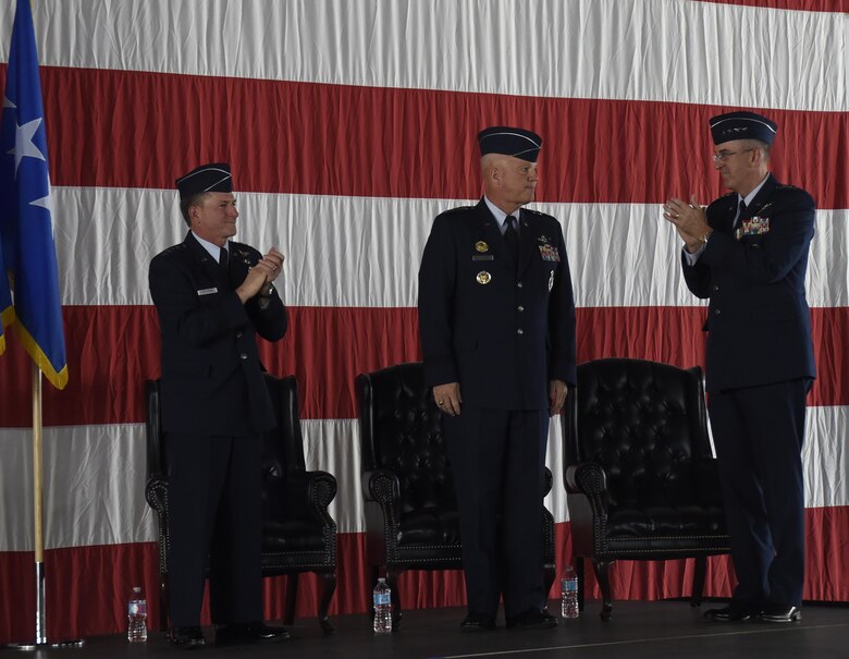 Right, Gen. John Hyten, outgoing commander of Air Force Space Command, claps with (left) Air Chief of Staff Gen. David L. Goldfein minutes after Gen. John Raymond took command of AFSPC, Oct. 25, 2016 at Peterson Air Force Base, Colo. Gen. Raymond was previously the Deputy Chief of Staff for Operations, Headquarters Air Force. (U.S. Air Force Photo/Airman 1st Class Dennis Hoffman)