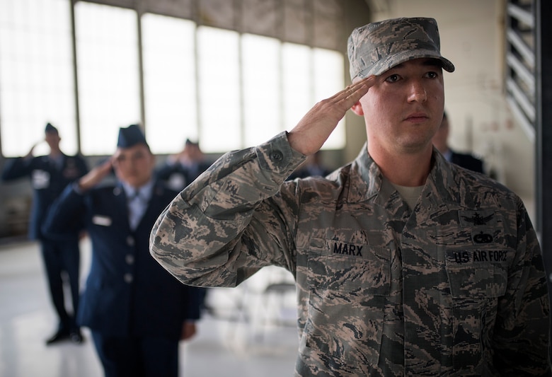 Tech. Sgt. William Marx, 21st Operations Support Squadron, salutes as the Air Force Space Command change of command ceremony begins, Oct. 25, 2016 at Peterson Air Force Base, Colo. Gen. John Raymond,  previously the Deputy Chief of Staff for Operations, Headquarters Air Force, took charge of AFSPC during the ceremony. (U.S. Air Force Photo/Tech. Sgt. David Salanitri)