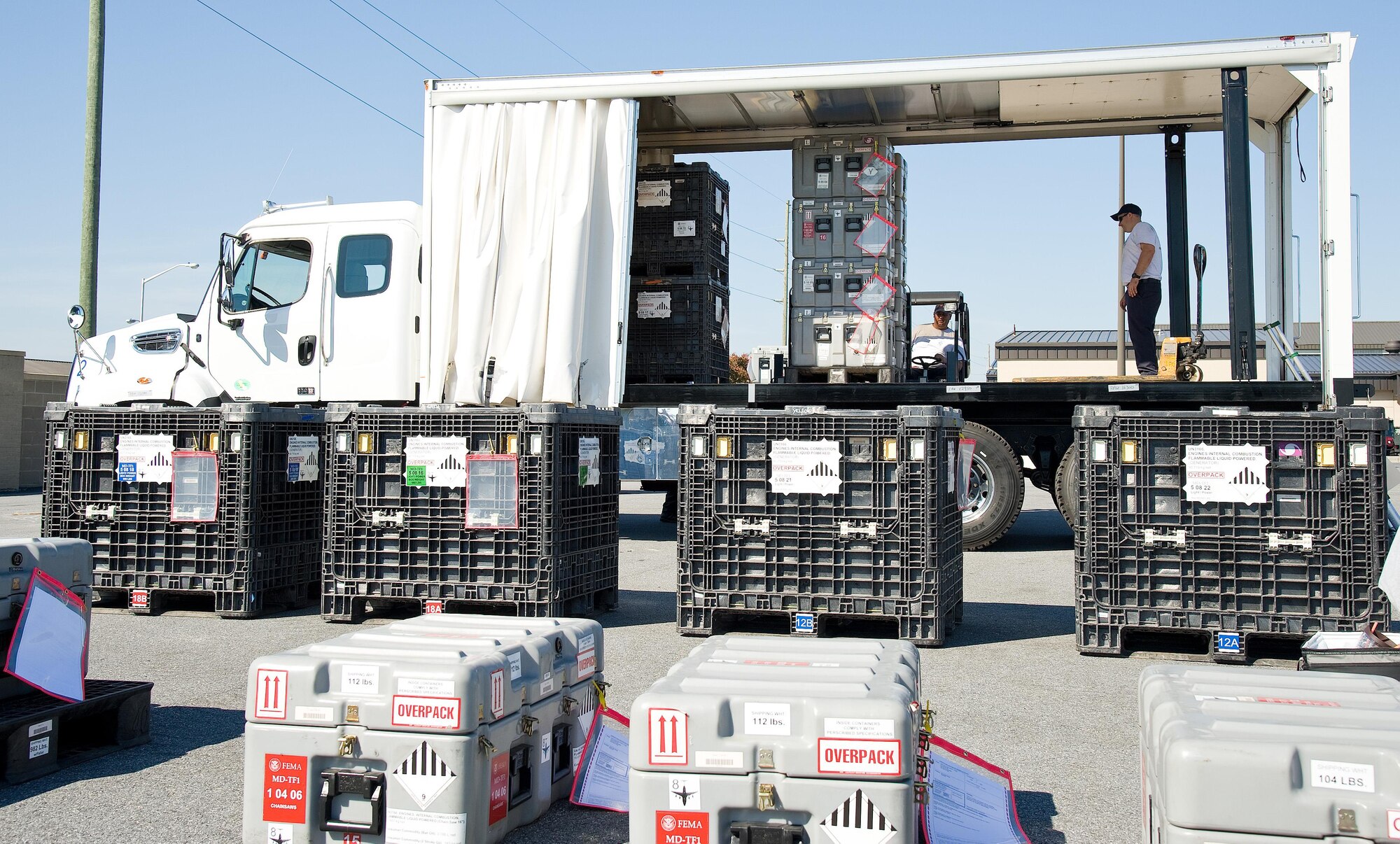 Members of the Maryland Task Force 1, Montgomery County Urban Search & Rescue Team, load their inspected cargo onto vehicle Oct. 18, 2016, at the 436th APS marshalling yard on Dover Air Force Base, Del. This particular vehicle with curtain-style sides facilitates quick access to cargo for either loading or unloading. The forklift in use mounts to the rear of the vehicle for easy transportability. (U.S. Air Force photo by Roland Balik)