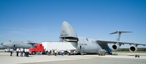 Chris Hinkle, Maryland Task Force 1 logistics specialist from the Montgomery County Urban Search & Rescue Team, backs up an International truck with a 53-foot trailer into the cargo compartment of a C-5M Super Galaxy Oct. 18, 2016, on Dover Air Force Base, Del. Hinkle attempted to back the truck and trailer weighing over 60,000-pounds into the cargo compartment under the guidance of 9th Airlift Squadron loadmasters, using various configurations of the DOMOPS Airlift Modular Approach Shoring ramps. (U.S. Air Force photo by Roland Balik)
