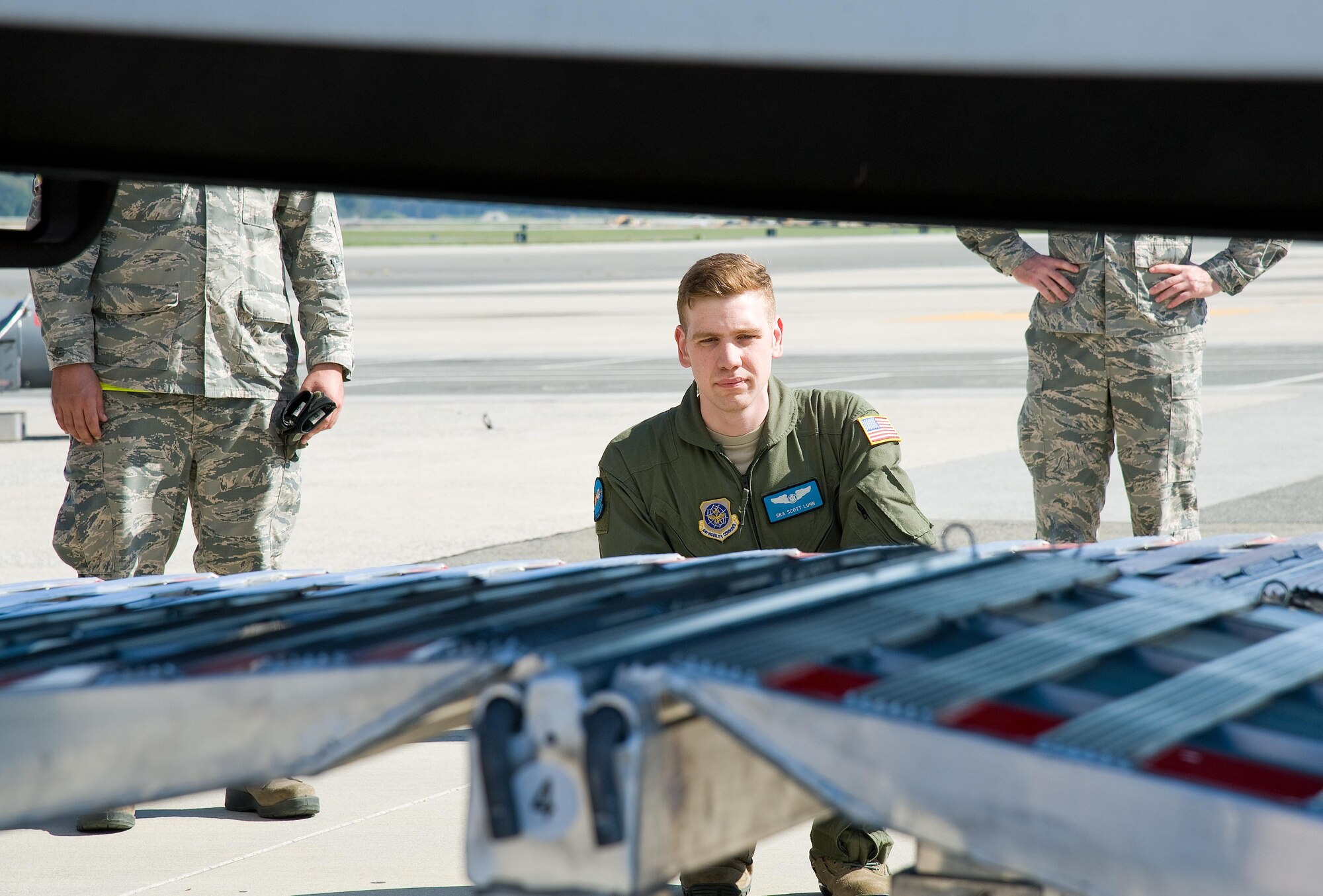 Senior Airman Scott Lunn, 9th Airlift Squadron loadmaster, keeps watch on the bottom of a 53-foot trailer as it slowly goes up the DAMAS 26K loading ramp and into the cargo compartment of a C-5M Super Galaxy Oct. 18, 2016, on Dover Air Force Base, Del. The loading ramp system known as DAMAS 26K which stands for DOMOPS Airlift Modular Approach Shoring, can be set up by two to three individuals in 14 minutes and was used by the Montgomery County’s Urban Search & Rescue Team during this training event to validate loading procedures and ramp configurations specific to their vehicles. (U.S. Air Force photo by Roland Balik)