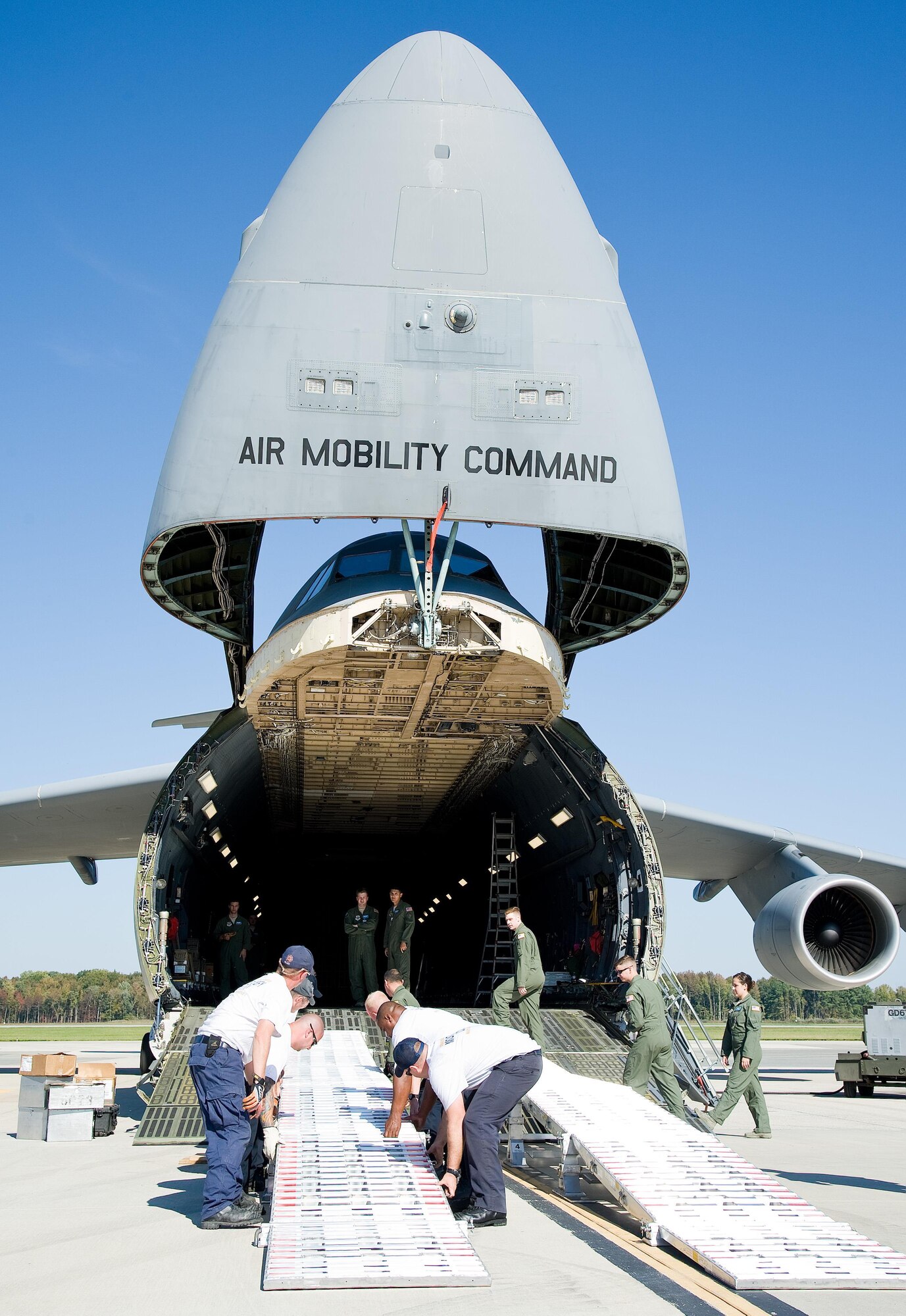 Maryland Task Force 1 team members from the Montgomery County’s Urban Search & Rescue Team, reconfigure one of the loading ramps for the next vehicle to be loaded onto a C-5M Super Galaxy Oct. 18, 2016, Dover Air Force Base, Del. The loading ramp system known as DAMAS 26K which stands for DOMOPS Airlift Modular Approach Shoring, be set up by two to three individuals in 14 minutes, replacing an antiquated 6,000-pound wood shoring kit that required a team of personnel and a forklift to set up. (U.S. Air Force photo by Roland Balik)