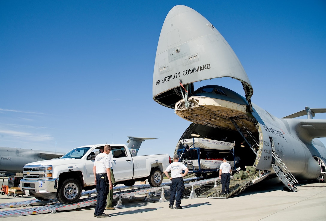 Mike Crawford, Maryland Task Force 1 logistics manager for the Montgomery County Urban Search & Rescue Team, backs a Chevy HD 3500 pickup truck and boat trailer up the loading ramp and into the cargo compartment of a C-5M Super Galaxy Oct. 18, 2016, on Dover Air Force Base, Del. Loadmasters from the 9th Airlift Squadron guided Crawford up the DOMOPS Airlift Modular Approach Shoring ramps, also known as DAMAS 26K. (U.S. Air Force photo by Roland Balik)