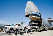 Mike Crawford, Maryland Task Force 1 logistics manager for the Montgomery County Urban Search & Rescue Team, backs a Chevy HD 3500 pickup truck and boat trailer up the loading ramp and into the cargo compartment of a C-5M Super Galaxy Oct. 18, 2016, on Dover Air Force Base, Del. Loadmasters from the 9th Airlift Squadron guided Crawford up the DOMOPS Airlift Modular Approach Shoring ramps, also known as DAMAS 26K. (U.S. Air Force photo by Roland Balik)