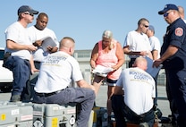 Anna Reed, 436th Aerial Port Squadron hazardous material inspector processor, center, reviews hazardous cargo declaration paperwork prepared by Maryland Task Force 1 members, a Montgomery County’s Urban Search & Rescue Team, Oct. 18, 2016, at the 436th APS marshalling yard on Dover Air Force Base, Del. Reed ensured all cargo being loaded onto a C-5M Super Galaxy was properly documented and noted as airworthy. (U.S. Air Force photo by Roland Balik)