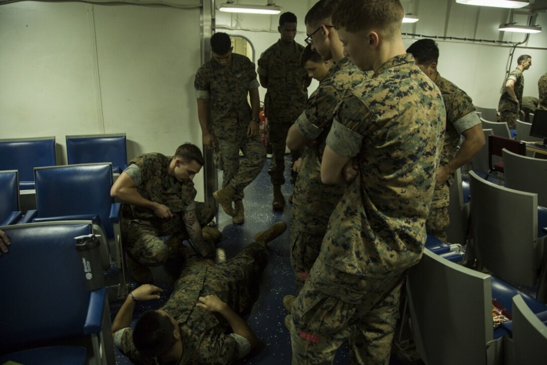U.S. Navy Petty Officer 3rd Class Timothy Pryor, a hospital corpsman with the 31st Marine Expeditionary Unit, demonstrates proper tourniquet use during a Combat Lifesaver Course aboard the amphibious assault ship USS Bonhomme Richard (LHD 6) Oct. 22, 2016. Marines taking the course learn basic lifesaving skills to respond to critical situations. (U.S. Marine Corps photo by Cpl. Samantha Villarreal) 