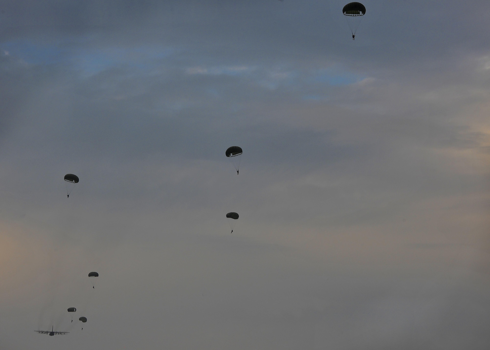 U.S. Air Force combat controllers assigned to the 1st Special Operations Squadron and military members from the Republic of Korea (ROK) 255th Special Operations Squadron, perform a static line jump out of a U.S. Air Force MC-130H Combat Talon II, assigned to the 353rd Special Operations Group, at Kunsan Air Base, Republic of Korea, Oct. 22, 2016. Members from the 320th Special Tactics Squadron and 1st SOS worked with the ROK 255th SOS to enhance U.S. and ROK Air Force Special Operations Forces' capabilities. They conducted infiltration methods, jump clearing team operations, airfield establishment, aircraft control and close air support familiarization. (U.S. Air Force photo by Senior Airman Colville McFee/Released)
