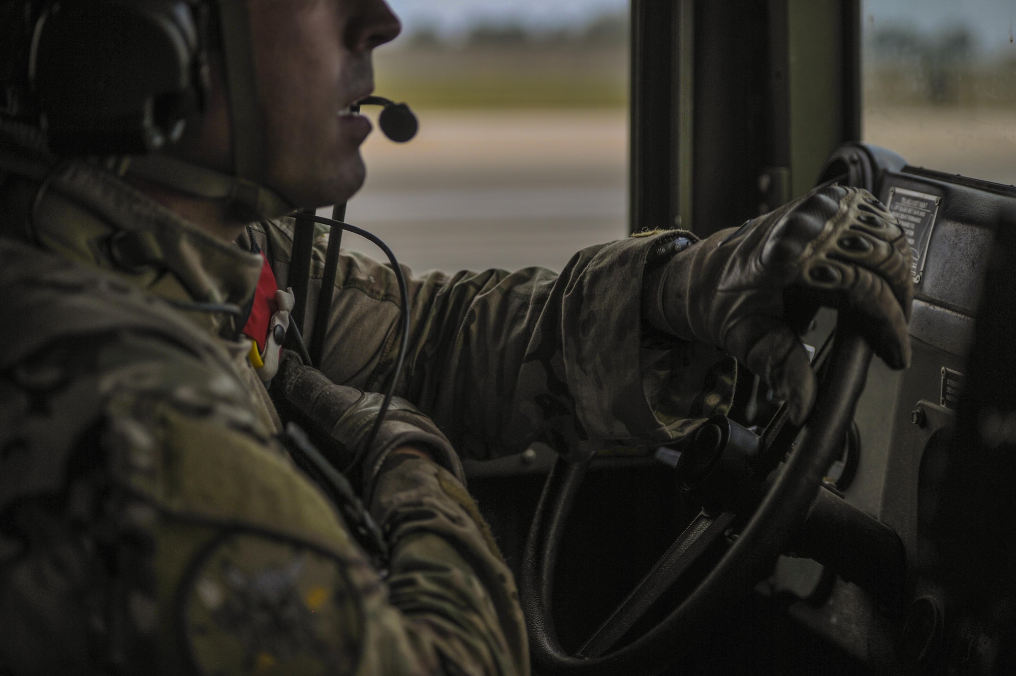 A U.S. Air Force combat controller assigned to the 1st Special Operations Squadron, drives a Humvee while using his radio to communicate at Kunsan Air Base, Republic of Korea, Oct. 22, 2016. Members from the 320th STS and 1st SOS worked with the ROK 255th SOS to enhance U.S. and ROK Air Force Special Operations Forces' capabilities. They conducted infiltration methods, jump clearing team operations, airfield establishment, aircraft control and close air support familiarization. (U.S. Air Force photo by Senior Airman Colville McFee/Released)