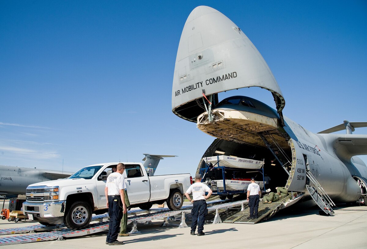 Mike Crawford, Maryland Task Force 1 logistics manager for the Montgomery County Urban Search & Rescue Team, backs a Chevy HD 3500 pickup truck and boat trailer up the loading ramp and into the cargo compartment of a C-5M Super Galaxy Oct. 18, 2016, on Dover Air Force Base, Del. Loadmasters from the 9th Airlift Squadron guided Crawford up the DOMOPS Airlift Modular Approach Shoring ramps, also known as DAMAS 26K. (U.S. Air Force photo by Roland Balik)