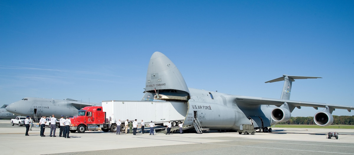 Chris Hinkle, Maryland Task Force 1 logistics specialist from the Montgomery County Urban Search & Rescue Team, backs up an International truck with a 53-foot trailer into the cargo compartment of a C-5M Super Galaxy Oct. 18, 2016, on Dover Air Force Base, Del. Hinkle attempted to back the truck and trailer weighing over 60,000-pounds into the cargo compartment under the guidance of 9th Airlift Squadron loadmasters, using various configurations of the DOMOPS Airlift Modular Approach Shoring ramps. (U.S. Air Force photo by Roland Balik)