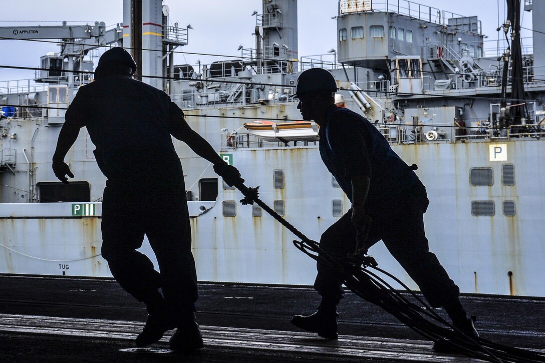 Sailors on the USS Nimitz prepare to load ordnance from the dry cargo/ammunition ship USNS Wally Schirra in the Pacific Ocean, Oct. 23, 2016. The Nimitz is conducting an ordnance-handling evolution to prepare for an upcoming deployment. Navy photo by Seaman Trenton J. Kotlarz