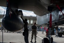 U.S. Air Force Senior Airman Zahmann McAdory, 67th Aircraft Maintenance Unit weapons load standardization crew member, tightens a bolt in preparation for loading a missile onto an F-15 Eagle during a quarterly weapons load competition Oct. 24, 2016, at Kadena Air Base, Japan. The weapons load competition and friendly competition between 67th and 44th AMU encourages teamwork and camaraderie. (U.S. Air Force photo by Senior Airman Lynette M. Rolen/Released)