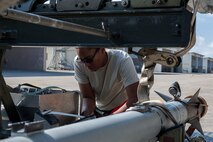 U.S. Air Force Staff Sgt. Niquita Newton, 67th Aircraft Maintenance Unit weapons load team chief, retrieves tools during the third quarter weapons load competition Oct. 24, 2016, at Kadena Air Base, Japan. Accuracy was of the utmost importance during the competition; if crew members drop any tools during the competition, points get deducted from their score. (U.S. Air Force photo by Senior Airman Lynette M. Rolen/Released)