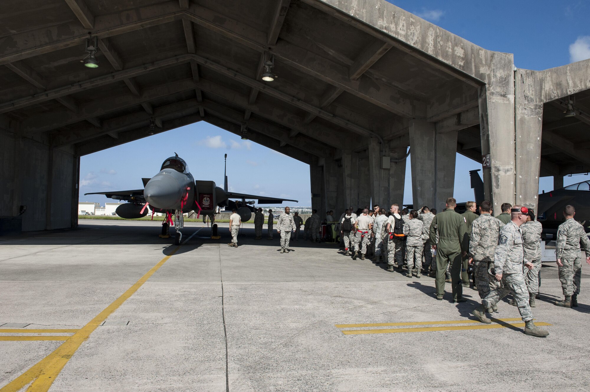 Airmen from the 18th Aircraft Maintenance Squadron congratulate 67th Aircraft Maintenance Unit weapons load crew team members at the conclusion of the third quarter weapons load competition Oct. 24, 2016, at Kadena Air Base, Japan. The weapons load competition is a time-honored tradition between the 67th and 44th AMU, showcasing each unit’s ability to quickly prepare an F-15 Eagle for real-world contingencies. (U.S. Air Force photo by Senior Airman Lynette M. Rolen/Released)
