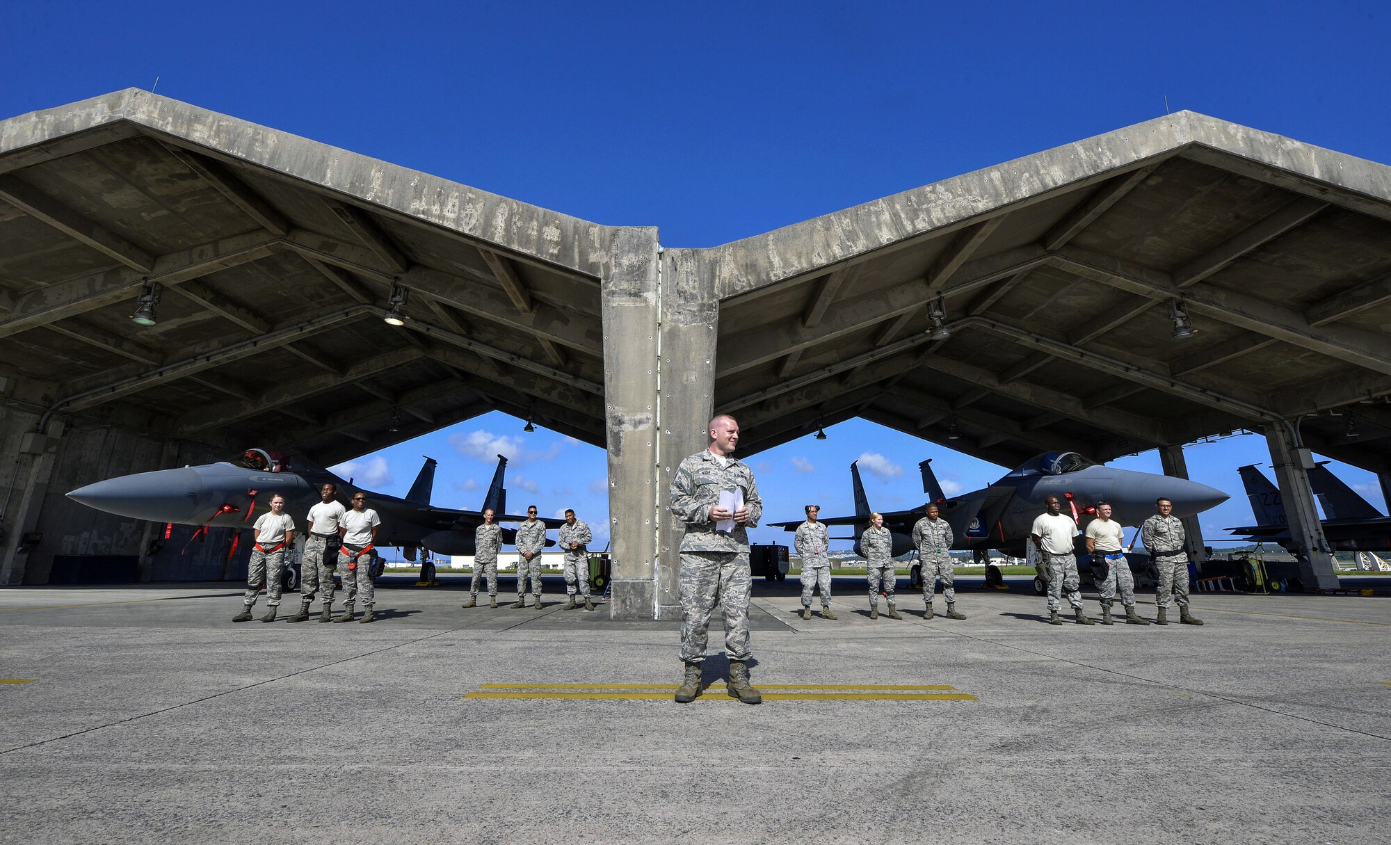 U.S. Air Force Tech. Sgt. Benjamin Bouvy, 18th Aircraft Maintenance Squadron weapons load standardization crew member, gives the opening remarks of a quarterly weapons load competition Oct. 24, 2016, at Kadena Air Base, Japan. The competition pitted teams from different AMUs against each other in a race to complete the loading of weapons onto F-15 Eagles. (U.S. Air Force photo by Naoto Anazawa/Released)
