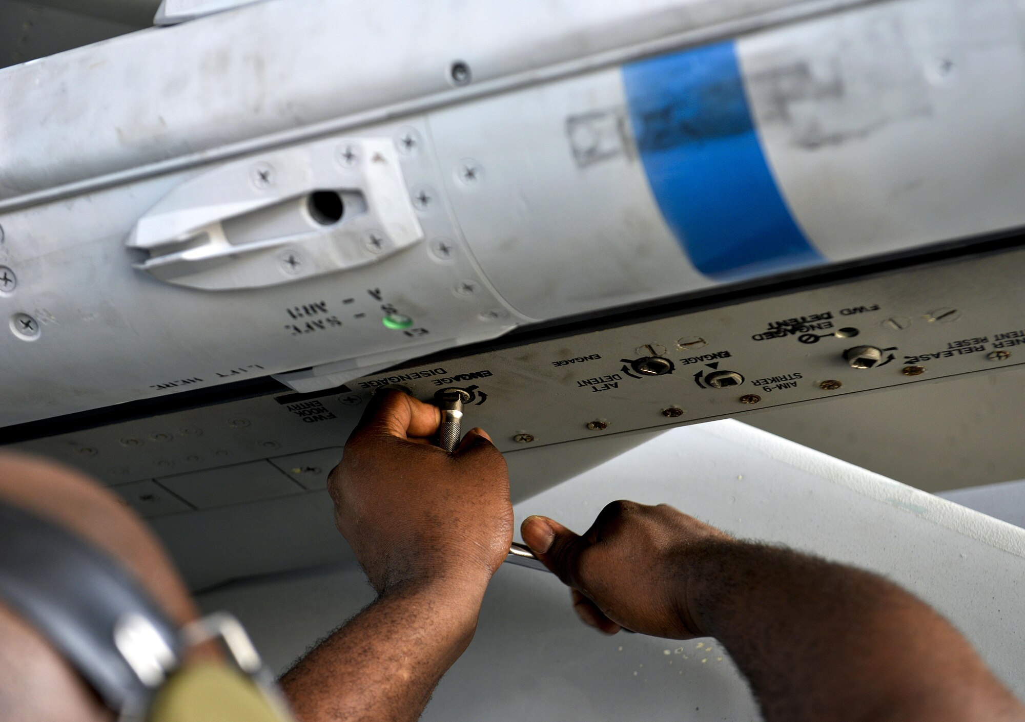 U.S. Air Force Staff Sgt. Chris Fleming, 18th Aircraft Maintenance Squadron weapons load team chief, tightens the screw of a LAU-128 missile rail launcher during a quarterly weapons load competition Oct. 24, 2016, at Kadena Air Base, Japan. Load crew competitions give weapons personnel the opportunity to display their war-fighting skills and unveil the best weapons load crew for each quarter throughout the year. (U.S. Air Force photo by Naoto Anazawa/Released)
